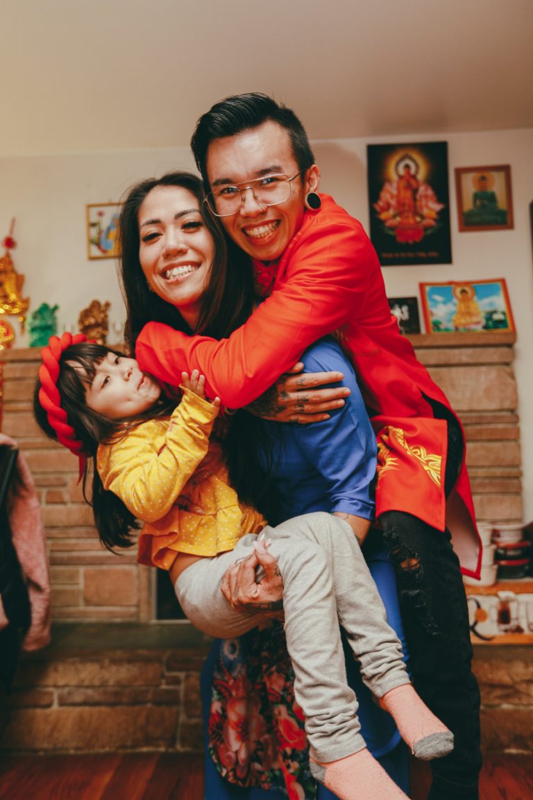 a man and a woman holding a child in their arms