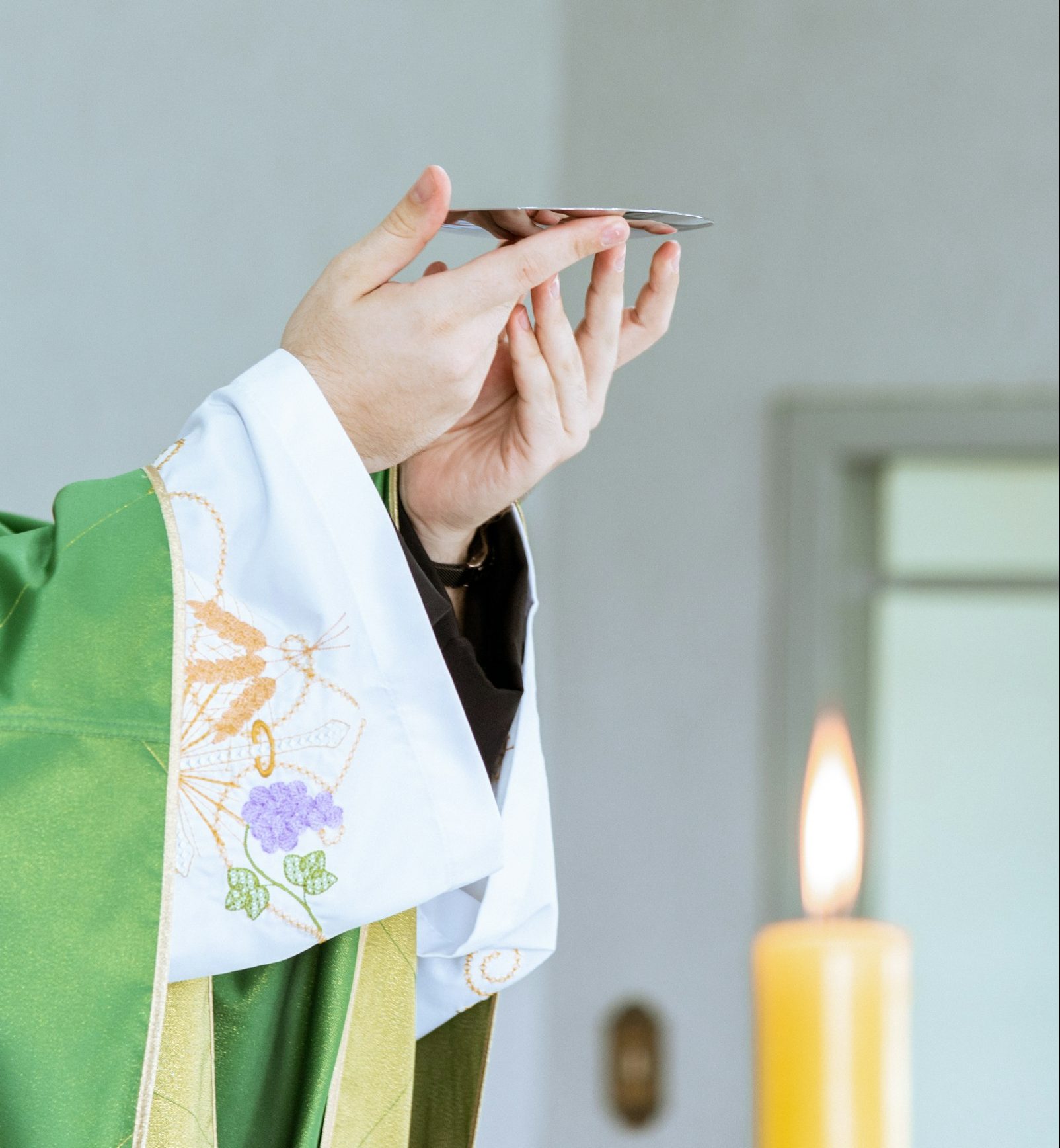 a person in a priest's robe holding a cell phone