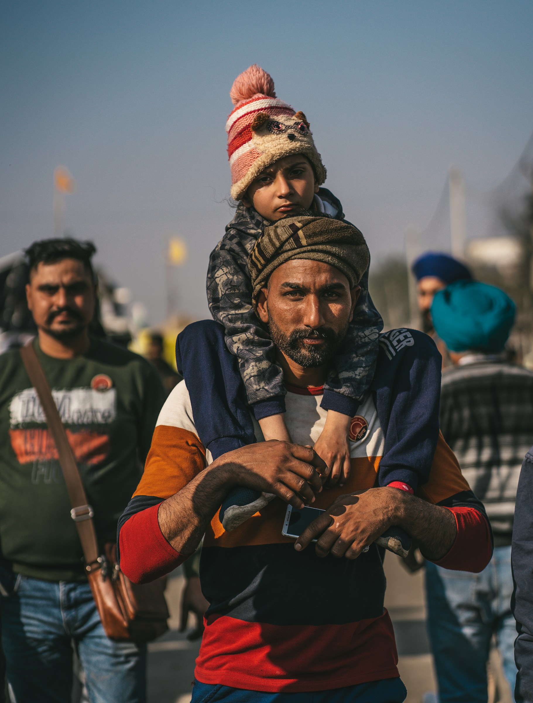 a man carrying a child on his shoulders